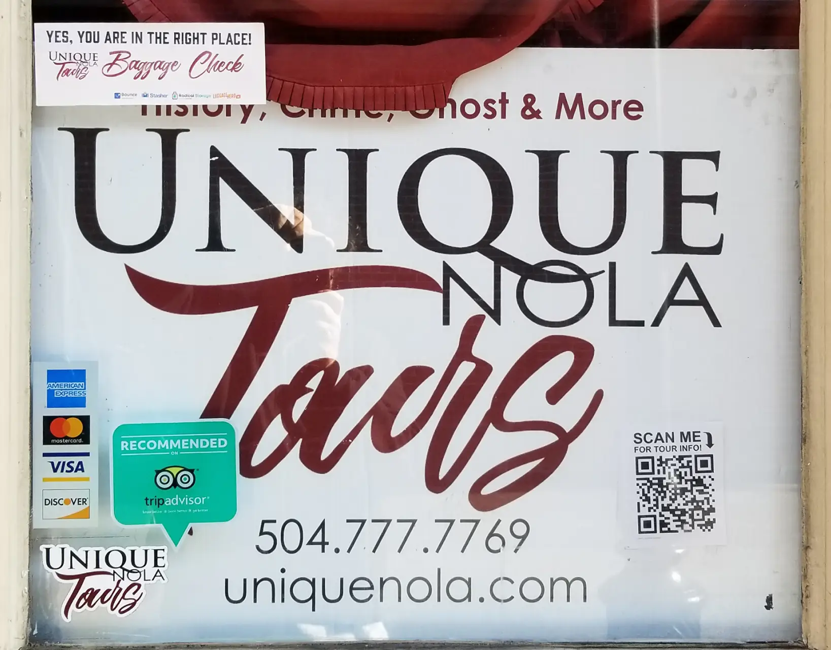 The store front of Unique Nola Tours with a QR Code in the bottom right corner.