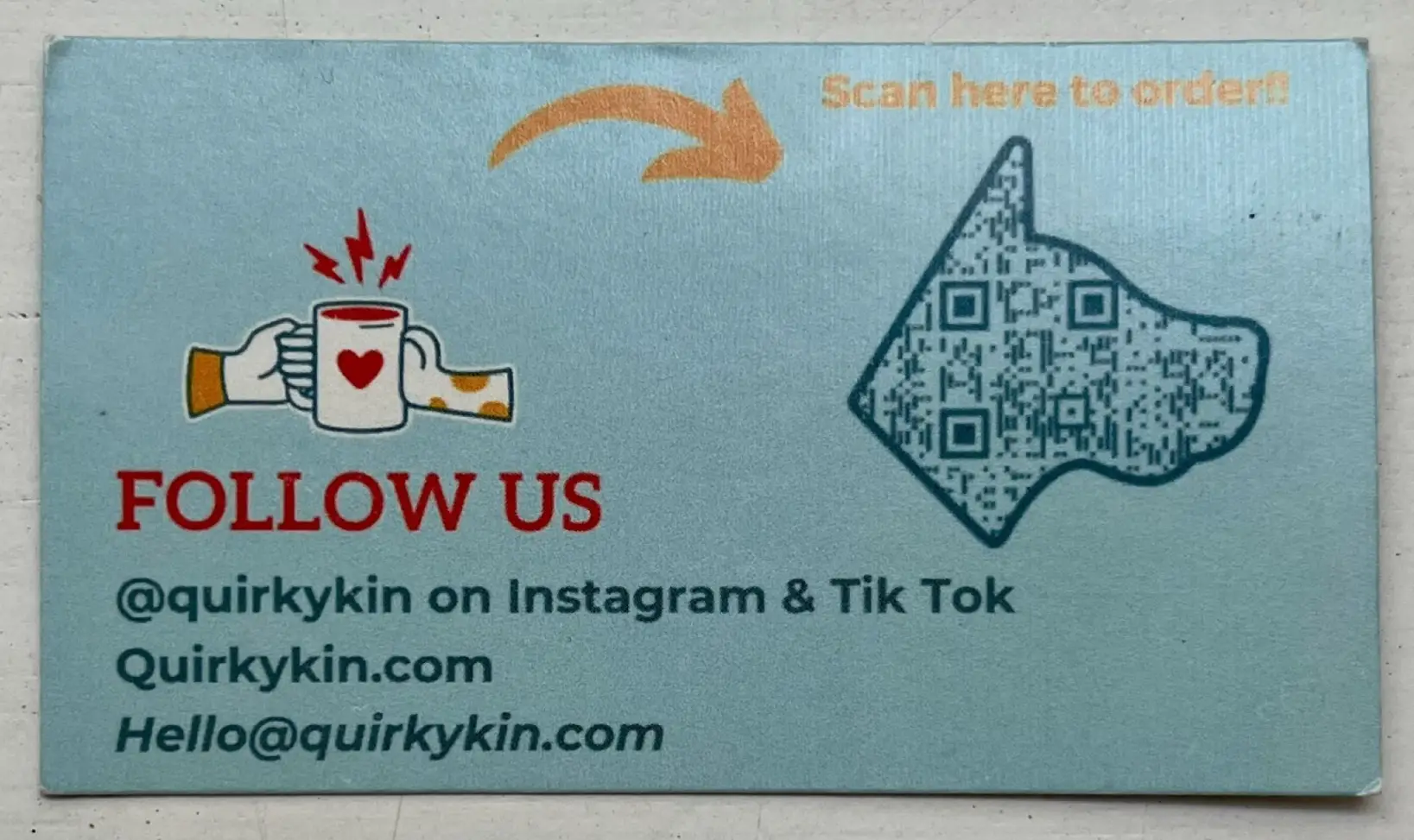 A blue ordering card with a “Follow us” call to action and a dog-shaped QR Code.