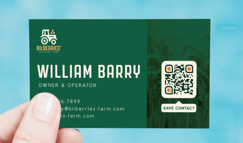 Hand holding a green business card with a QR Code in the bottom corner.