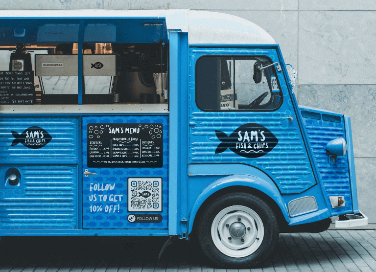 A blue and white food truck with a scannable QR Code on it. 