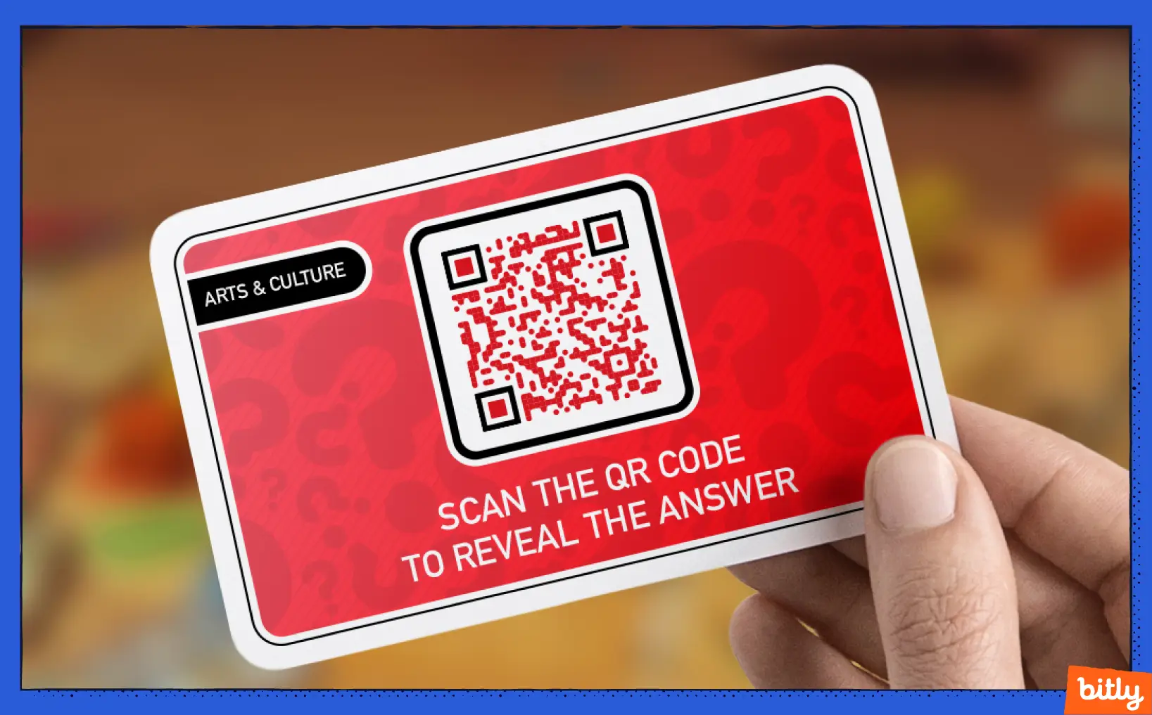 A red Arts & Culture Card with a QR Code and a scan the QR Code to reveal the answer call-to-action