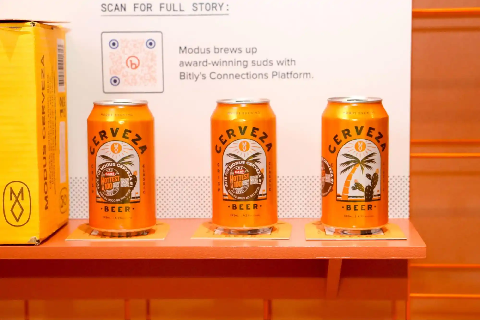 Display of Modus Brewring's beers at Bitly's booth at Advertising Week 2023 featuring a QR Code