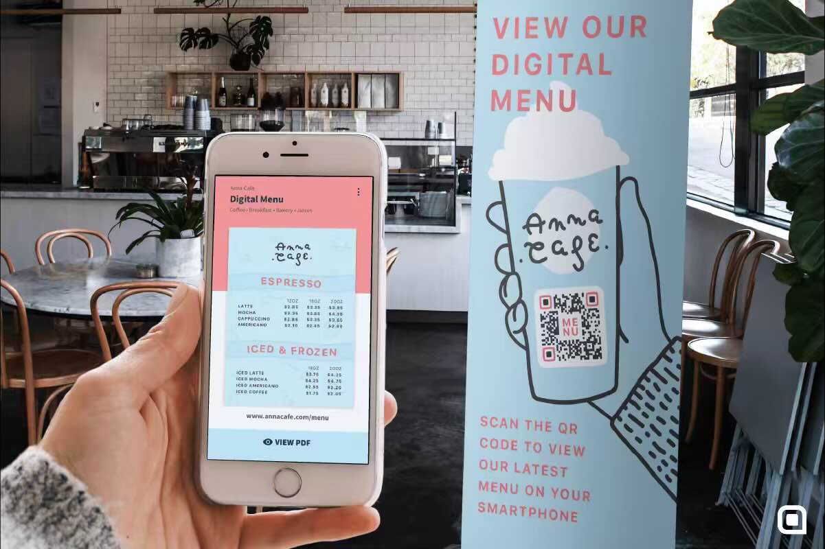 A person holding their smartphone with a cafe menu pulled up next to the cafe banner which has a QR Code for their menu on it