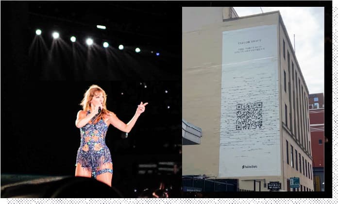 Taylor Swift at a live performance next to a QR Code on the side of a building in Chicago.