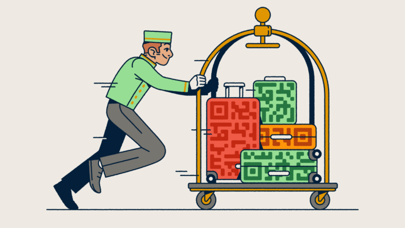 A bellhop pushing a luggage cart with several suitcases that have QR Code prints on them.